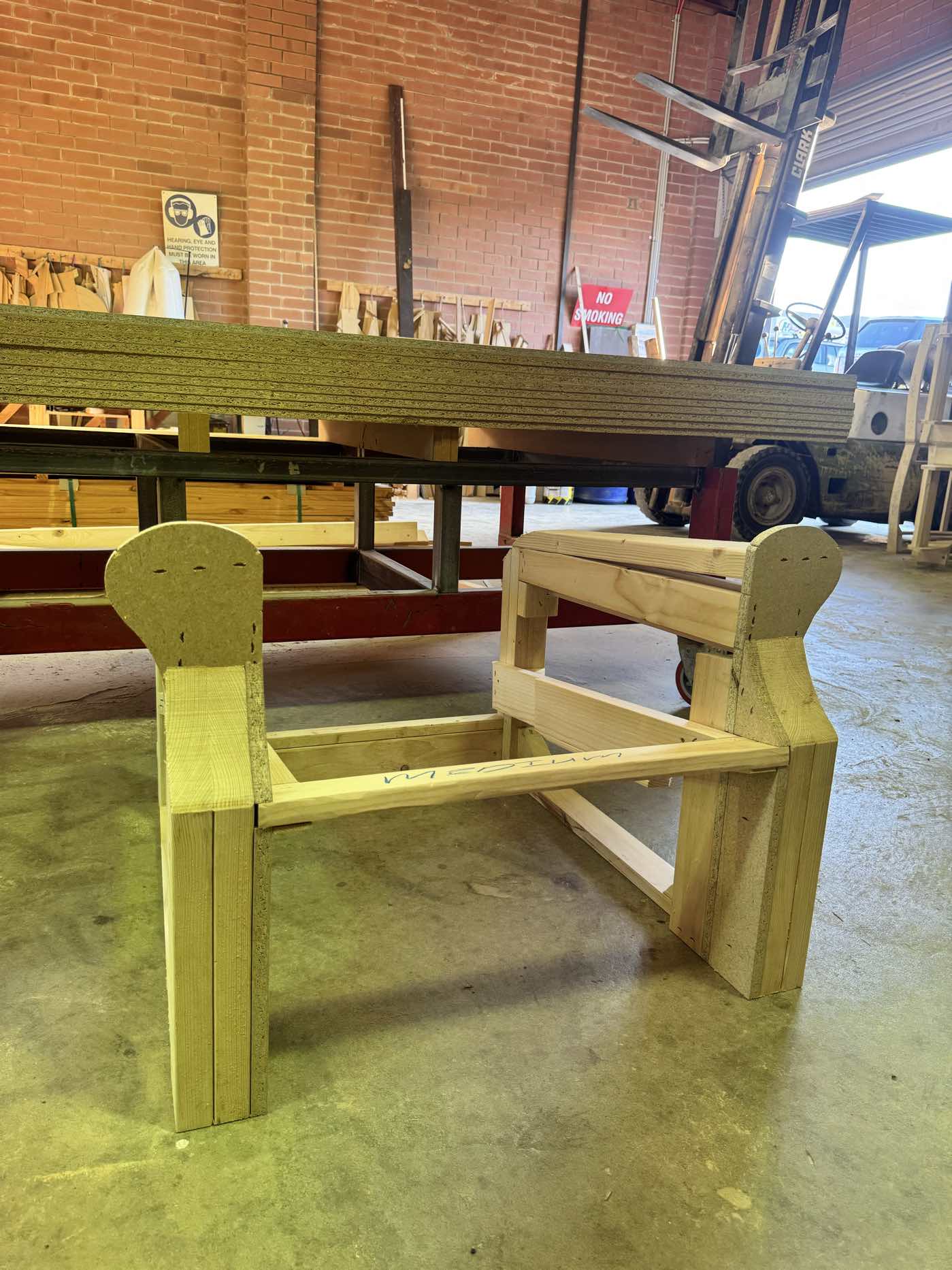 Sofa frame with curved arms in raw timber